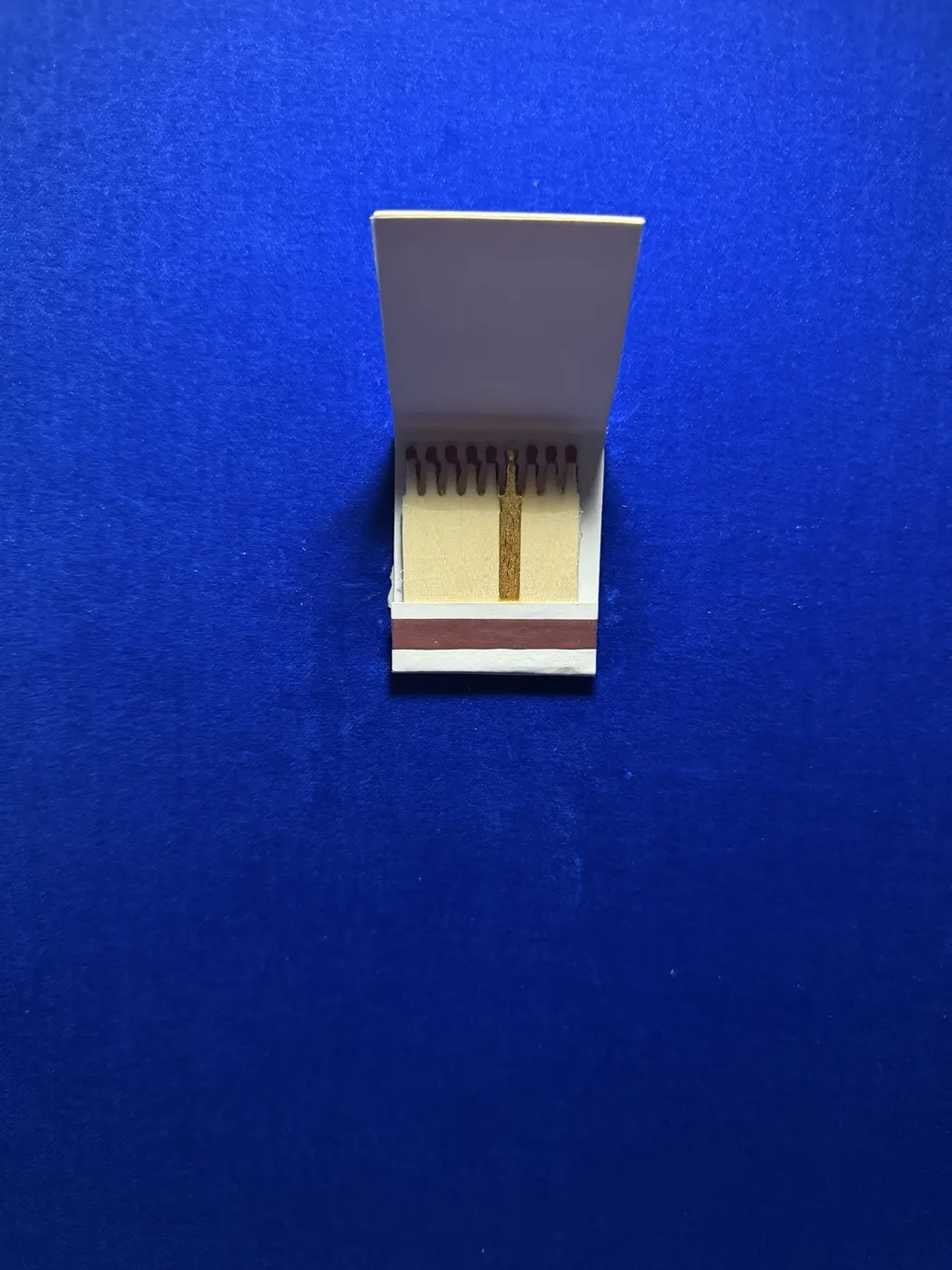 Matchbook with one gilded match against blue velvet, work HR-PC-06 Mrs Ammann