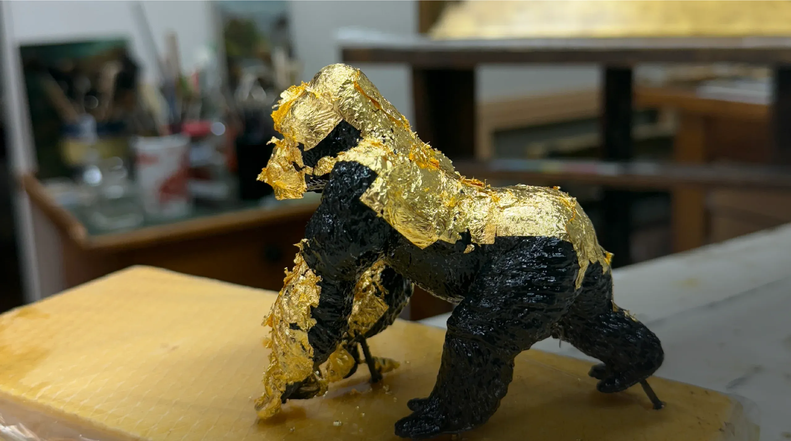Gilding a gorilla in the workshop
